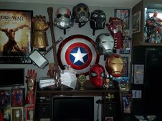 a room filled with lots of different types of masks on top of a wooden desk