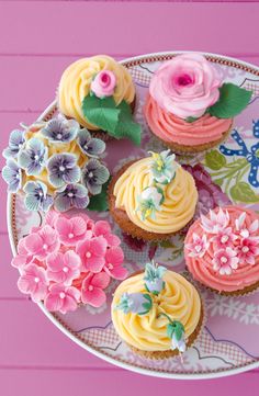 cupcakes decorated with flowers on a plate