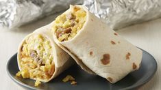 two burritos sitting on top of a blue plate