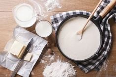 the table is covered with baking supplies and utensils