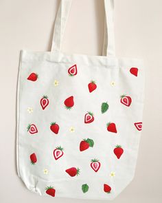 "Hand painted canvas tote bag in the pattern \"strawberry fields\"  The tote is 16 inches long by 13 inches wide, and the base of the bag is 4 inches" Hand Painted Tote Bag For Summer, Hand Painted Summer Tote Bag, Summer Strawberry Print Bag For Daily Use, Summer Strawberry Print Bags For Daily Use, Hand Painted White Cotton Canvas Bag, Hand Painted White Canvas Tote Bag, White Hand Painted Canvas Tote Bag, Hand Painted White Canvas Bag, Hand-painted White Canvas Bag