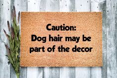 a door mat with the words caution dog hair may be part of the decor on it