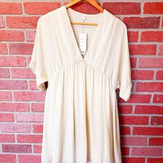 Nwt! Glam Ivory V Neck Short Sleeved Flowing Baby Doll Dress. Dress Fls Mid Thigh Off White Flowy V-neck Mini Dress, Flowy Off White V-neck Mini Dress, Flowy Off-white V-neck Mini Dress, Cream Short Sleeve Summer Dresses, Cream V-neck Mini Dress For Daywear, Cream Flowy V-neck Mini Dress, Daytime Short Sleeve Beige Mini Dress, Beige Short Sleeve Mini Dress For Daytime, Cream Short Sleeve Dress For Daytime