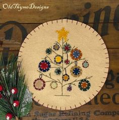 an embroidered christmas tree on a wooden table