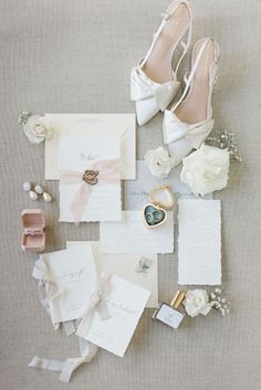 wedding stationery and shoes laid out on the floor