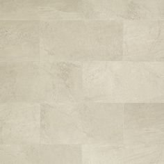 a white tile floor with different shades of beige