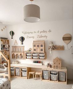 a child's room with toys and storage bins on the floor, walls painted white