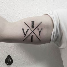 a man's arm with scissors and knitting needles tattoo on the left inner forearm