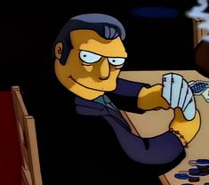 the simpsons character is playing cards at a table