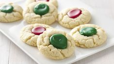 cookies with green and red icing on a white plate