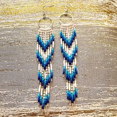 "These white and blue beaded Fringe Earrings are made with size 11/0 high quality seed beads, durable thread, Hypoallergenic earring hooks and silicone plugs.  They are incredibly lightweight while measuring 5\" (13 cm) long and 1\" (21mm) wide and weight 9 g. They will emphasize your individuality and compliment your personality on various occasions.  These seed beaded Fringe Earrings will go amazingly with any outfit, dressy or casual.  These beaded fringe earrings are lightweight and easy to wear for hours. Long Handmade seed bead fringe earrings, bohemian jewelry." Seed Bead Fringe Earrings, Bead Fringe Earrings, Blue Beaded Earrings, Bead Fringe, Beaded Fringe Earrings, Beaded Earrings Tutorials, Large Necklace, Earrings Bohemian, Earring Tutorial