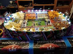 a football stadium themed table with snacks on it