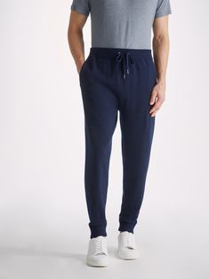 The Finley track pant is perfect in and out of the house, whether you're hitting the slopes, on a country walk or chilling on the sofa. With its elasticated waist, drawstring tie and slip-in side pockets, the aim was to create a garment that looks effortlessly chic but is still as comfortable to slip into as a favourite tracksuit. Our Finley navy men's cashmere track pants have a gradual taper to the leg and a ribbed waistband and ankle cuffs, for a relaxed yet stylish fit. Our philosophy is to Navy Relaxed Fit Joggers For Loungewear, Navy Bottoms For Loungewear In Winter, Drawstring Pants For Winter Lounging, Winter Drawstring Pants For Lounging, Comfortable Loungewear, Country Walk, Mens Cashmere, Cashmere Fabric, Navy Man