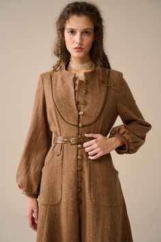 Enjoy the elegance and warmth of the season！ With its antique-style metal buttons and a loose silhouette, this luxurious wool coat is a cosy way to enhance your autumn/winter look. Exquisitely hand-woven, this coat is known for its durability, warmth and distinctive texture, effortlessly exuding your alluring fashion presence.   Indulge in the luxurious allure of our wool coat, crafted with a yarn-dyed technique that gives it a unique starry texture that will make you shine like a star! Featuring a maxi length, loose silhouette, Single-breasted, metal buttons, and versatile colours, the large patch pockets are practical and add a unique sense of design, making it easy to create a retro British vintage style. As you wear this coat, imagine yourself walking through the rolling hills of Scotl Long Wool Coat With Buttons, Wool Coat With Buttons And Long Sleeves, Wool Coat With Buttons, Brown Outerwear With Stand Collar And Buttons, Fall Outerwear With Covered Buttons, Winter Wool Button-up Coat With Buttons, Button-up Wool Coat For Winter, Fall Vintage Fashion Single-breasted Outerwear, Long Coat With Covered Buttons For Fall