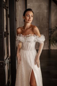 a woman in a white dress posing for the camera