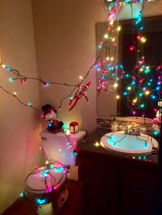 a bathroom decorated with christmas lights and decorations