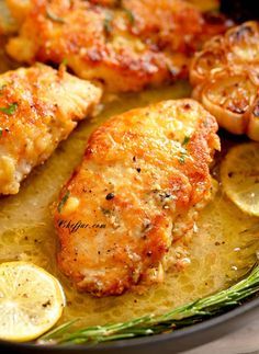 chicken with lemons and herbs in a skillet