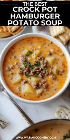 the best crock pot hamburger potato soup in a white bowl with crackers on the side