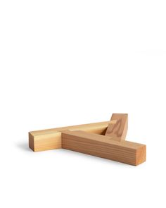 a wooden object sitting on top of a white surface