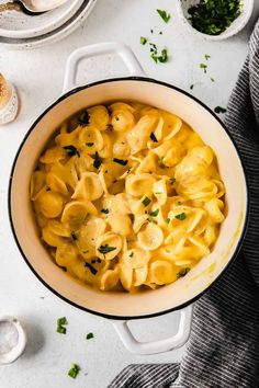 a pot filled with macaroni and cheese on top of a table