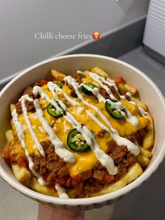 a bowl filled with chili cheese fries