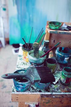 an artist's studio with paint and brushes