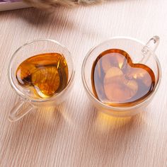 two cups filled with liquid sitting on top of a table