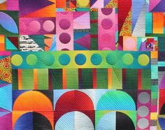 a colorful quilt with circles and shapes on it