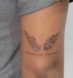 a woman with a tattoo on her arm that says, always love and two wings