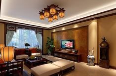 a living room filled with furniture and a flat screen tv on top of a wooden table