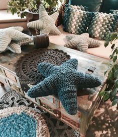 crocheted starfishs and pillows on an old coffee table