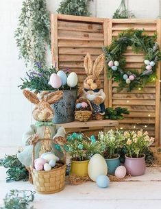 an easter display with bunnies, eggs and plants