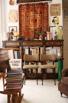 a living room filled with lots of furniture and books