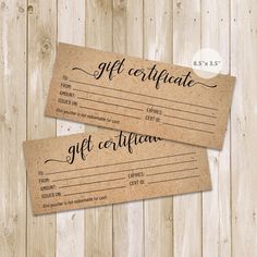 two brown gift certificates sitting on top of a wooden table