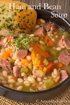 a bowl of ham and bean soup next to a piece of bread on a table