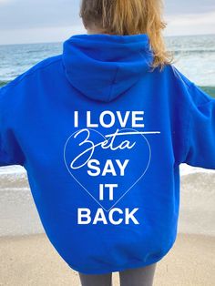 the back of a woman's blue hoodie that says i love delta say it back