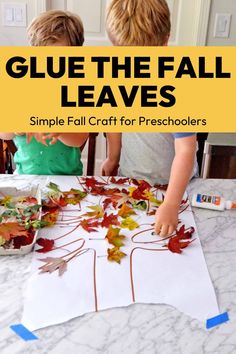 two children are making fall leaves with glue and paper on the table, while one child is