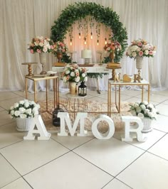 a table with flowers and letters on it that spell out the word's name