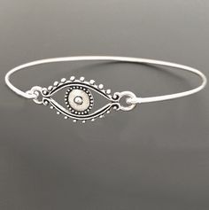 "Evil Eye Bracelet - Evil Eye Jewelry A detailed silver tone evil eye charm will be transformed into a beautiful evil eye bracelet with bangle band choice of silver filled or sterling silver. Also available with a gold tone evil eye and bangle band choice of brass or 14k gold filled band. If you want this option for your evil eye bracelet bangle, select from options when ordering. This evil eye bracelet looks great stacked with other bangles from my collection as you can see from the last 4th pi Adjustable Silver Bohemian Evil Eye Bracelet, Silver Evil Eye Bracelet Spiritual Style, Silver Spiritual Bracelet With Evil Eye, Spiritual Silver Bracelet With Evil Eye, Silver Bohemian Evil Eye Bracelet Gift, Bohemian Silver Evil Eye Bracelet, Silver Bohemian Evil Eye Bracelet, Metal Evil Eye Bracelet, Bohemian Adjustable Eye-shaped Jewelry