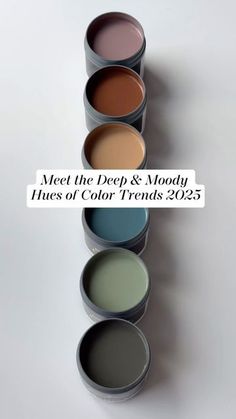 five paint cans with different colors and the words meet the deep & moody hues of color