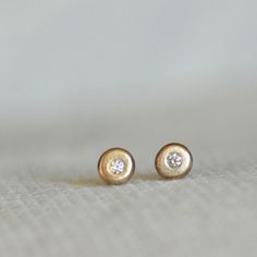 "Sparkly diamond post earrings...you choose the diamond color! I melted the little pebbles from a pieces of rich 14k recycled gold and hammered them into sweet little pebble shapes. I then set each pebble with a sparkly diamond. Because of the handmade process by which these earrings are made, the organically shaped \"pebbles\" are not perfectly matched, yet they go perfectly together like two pebbles collected along the same shore. These minimalist earrings, with their zen design, are the perfe Minimalist Round Diamond Earrings For Everyday, Minimalist Everyday Earrings With Bezel Setting, Minimalist Everyday Diamond Earrings, Everyday Minimalist Earrings With Bezel Setting, Everyday Minimalist Round Diamond Earrings, Tiny Diamond Earrings For Everyday, Minimalist Gold Diamond Earrings With Bezel Setting, Tiny Minimalist Diamond Earrings For Anniversary, Minimalist Single Cut Diamond Earrings For Everyday