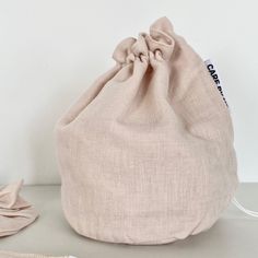 a bag sitting on top of a table next to a pair of scissors and thread