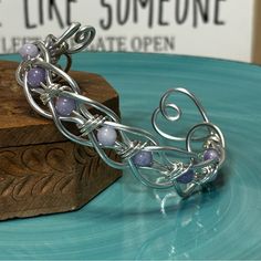 a metal bracelet sitting on top of a blue plate