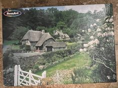 a puzzle box with an image of a country cottage