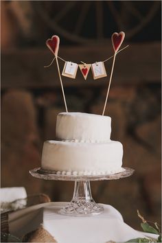 a wedding cake with two hearts on top