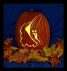 a carved pumpkin with an image of a woman's face on it, surrounded by leaves