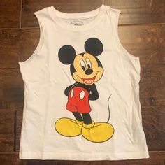 a white tank top with mickey mouse on it