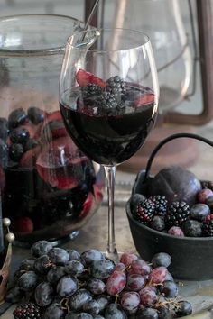 black and white photograph of wine, fruit and kettles