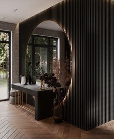 a room with wooden floors and black walls is seen through a circular mirror on the wall