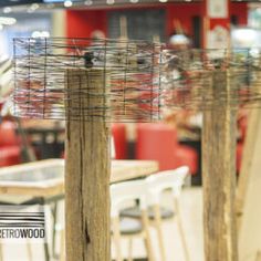 there are many chairs and tables in the store with wire coverings on them,